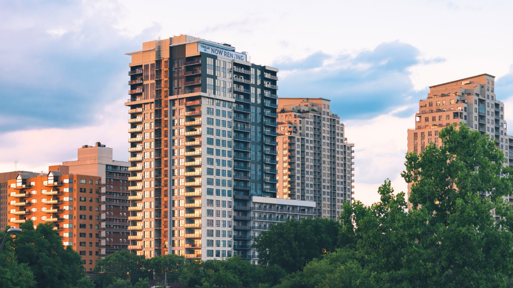 A photo of city apartment buildings surrounding by trees available for rent