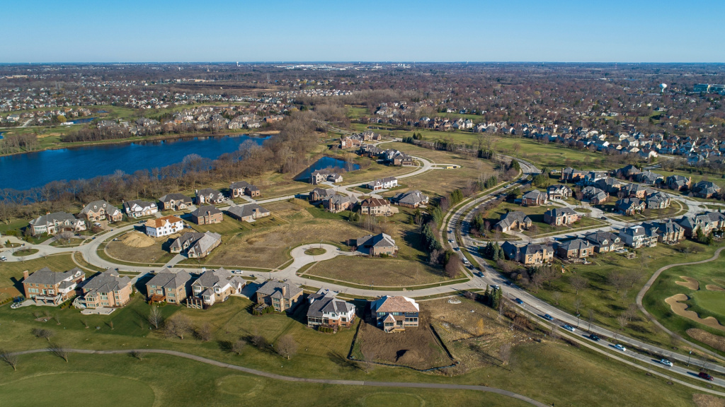 Aerial drone view image of a Vernon Hills, IL, suburban residential community next to a lake