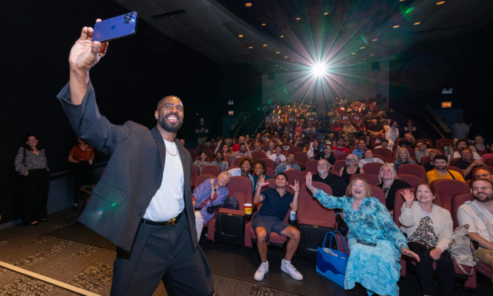 Image of actor Coleman Domingo taking a selfie with a crowd inside a venue screening at the Chicago International Film Festival