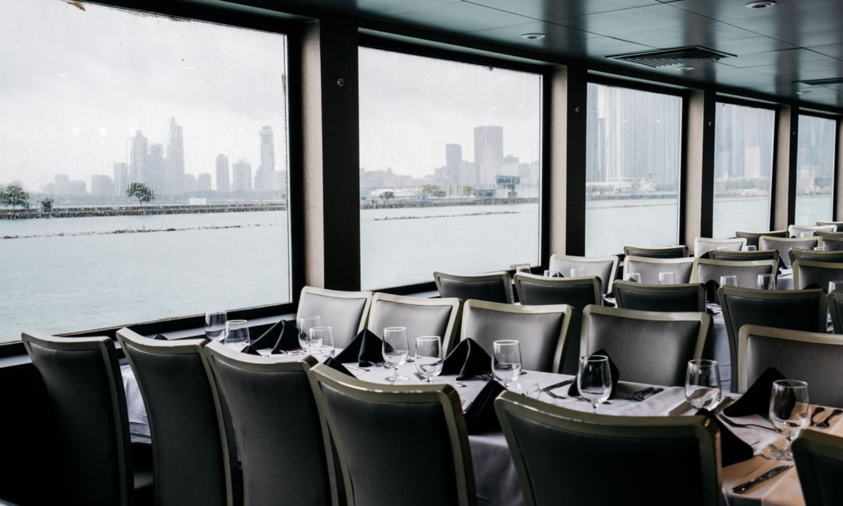 Image of empty seats inside a dinner cruise overlooking the Chicago skyline on Lake Michigan