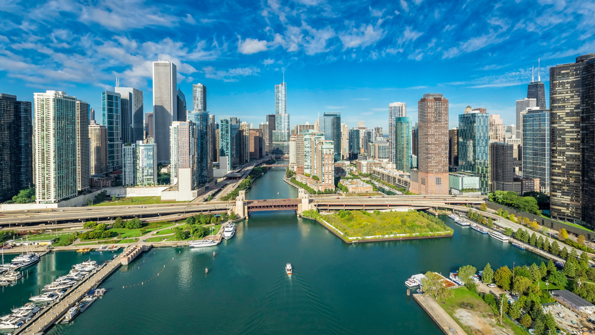 Wide-view image of Chicago skyscrapers with a waterfront lake