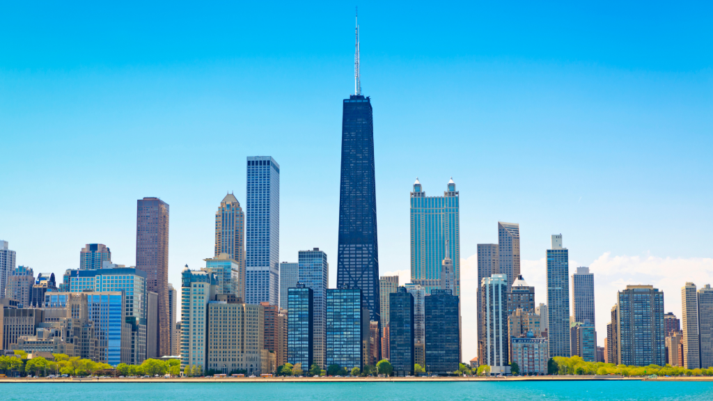 Image of the Chicago skyline behind the Lake Michigan shoreline during the day