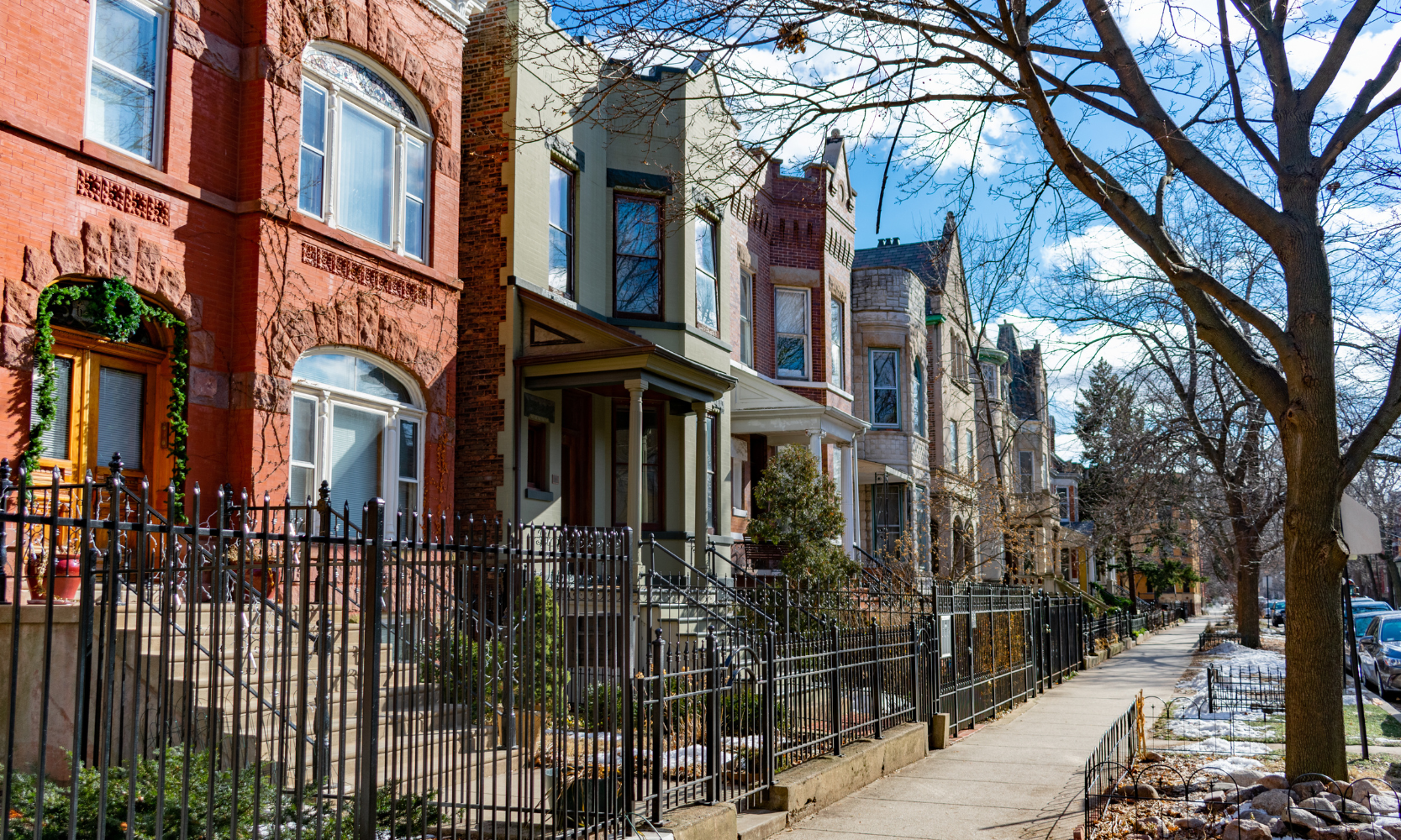 Image of English rowhouses with gated front yards and tree-lined snowy streets in Wicker Park, Chicago